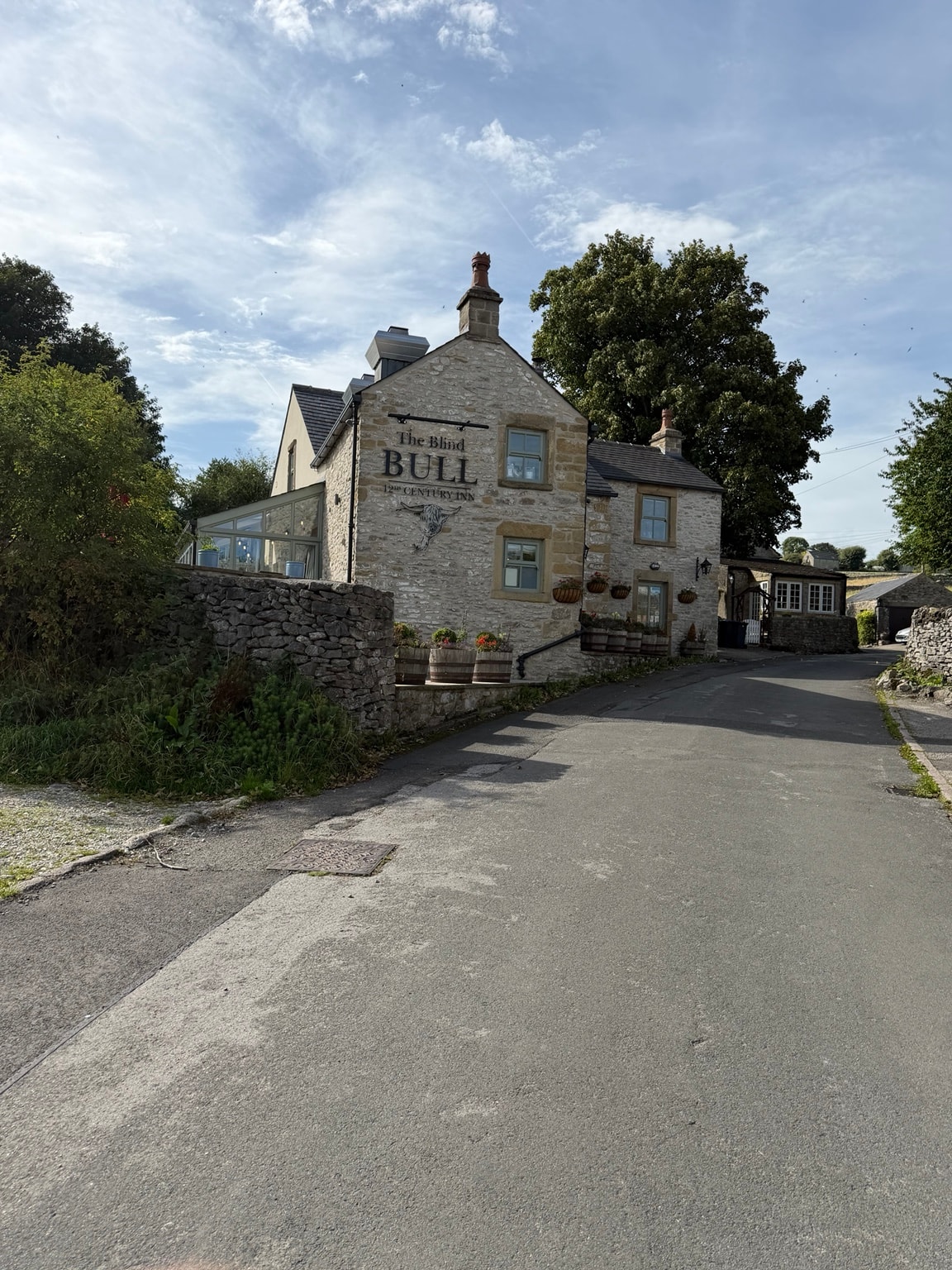 The Blind Bull, a 12th-century inn near Little Hucklow, seen from the lane
