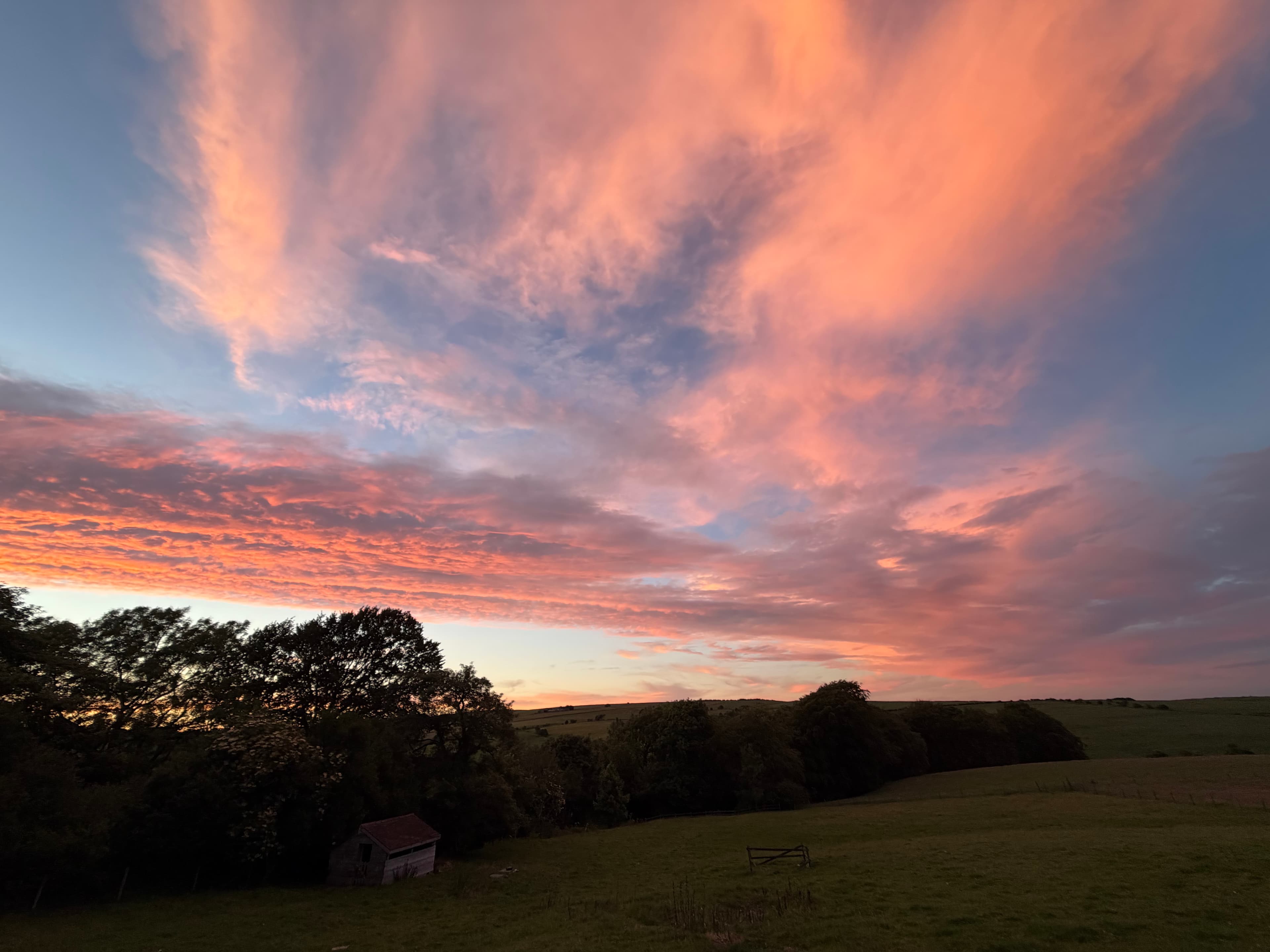 Farmland behind Lane Head Barns at sunset, seen from the terrace